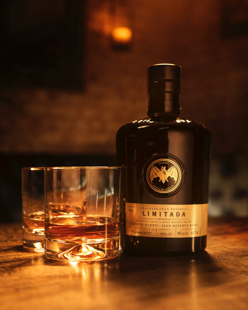 BACARDÍ Gran Reserva Limitada rum bottle positioned next to two whiskey glasses.