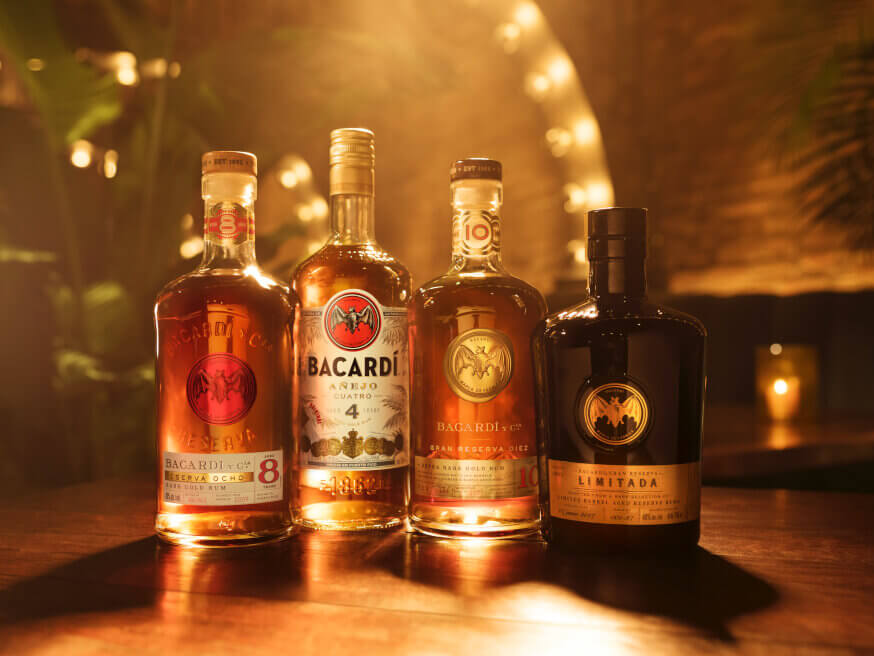 Four BACARDÍ rum bottles arranged to showcase different varieties.