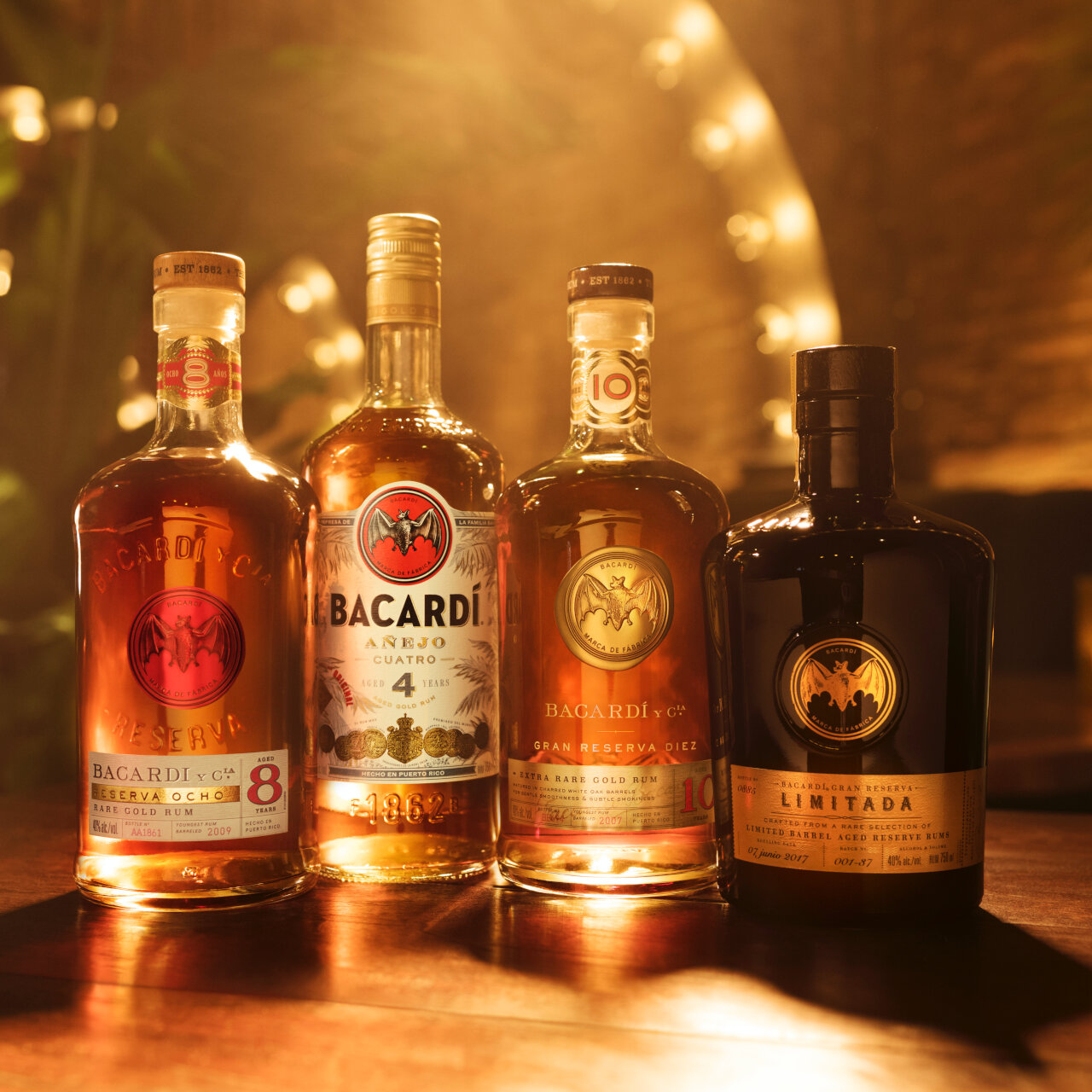 Four BACARDÍ rum bottles arranged in a line, displaying varied shapes and label designs.