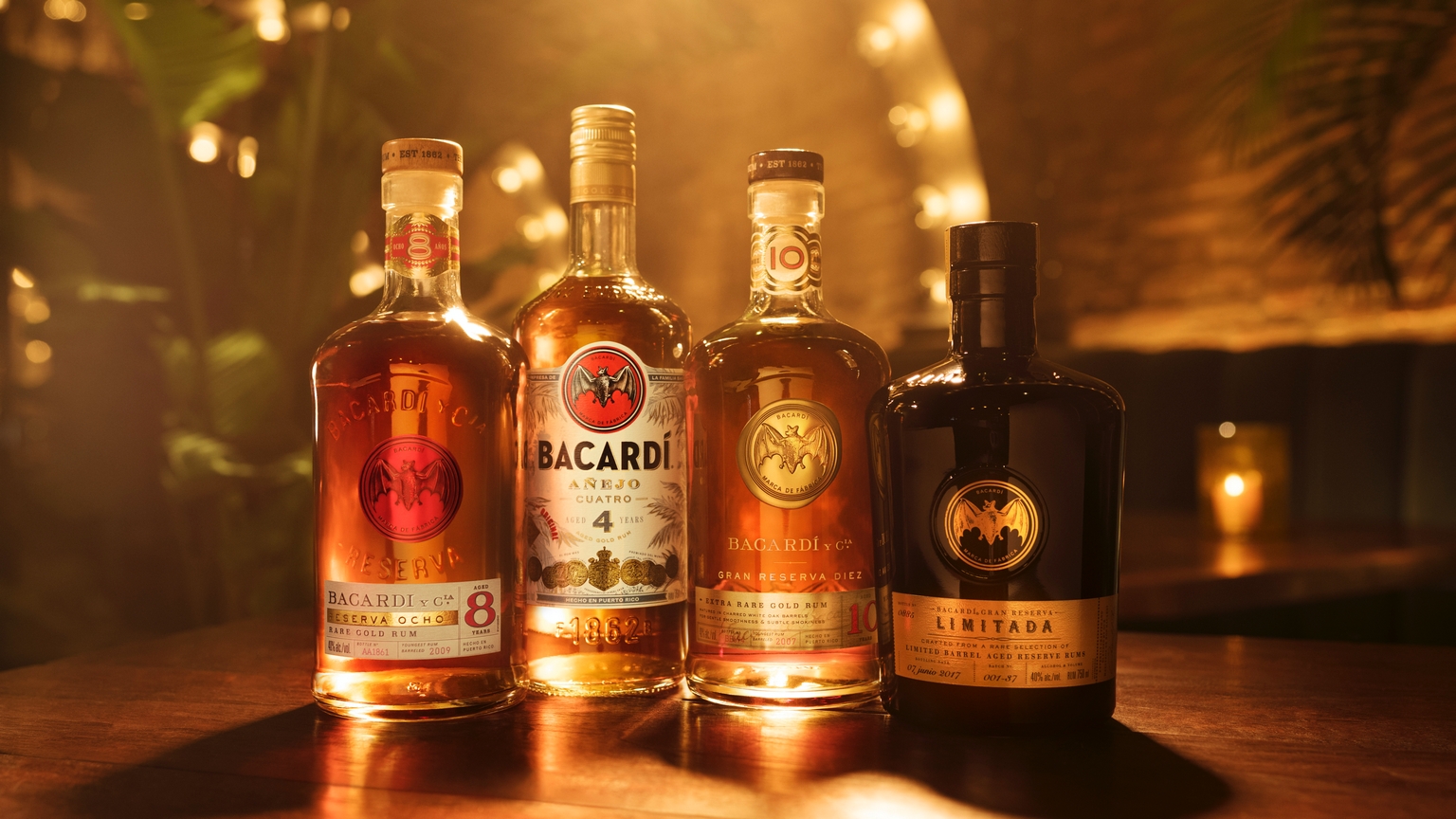 Four BACARDÍ rum bottles arranged in a row, showcasing Reserva Ocho, Añejo Cuatro, Gran Reserva Diez, Reserva Limitada.