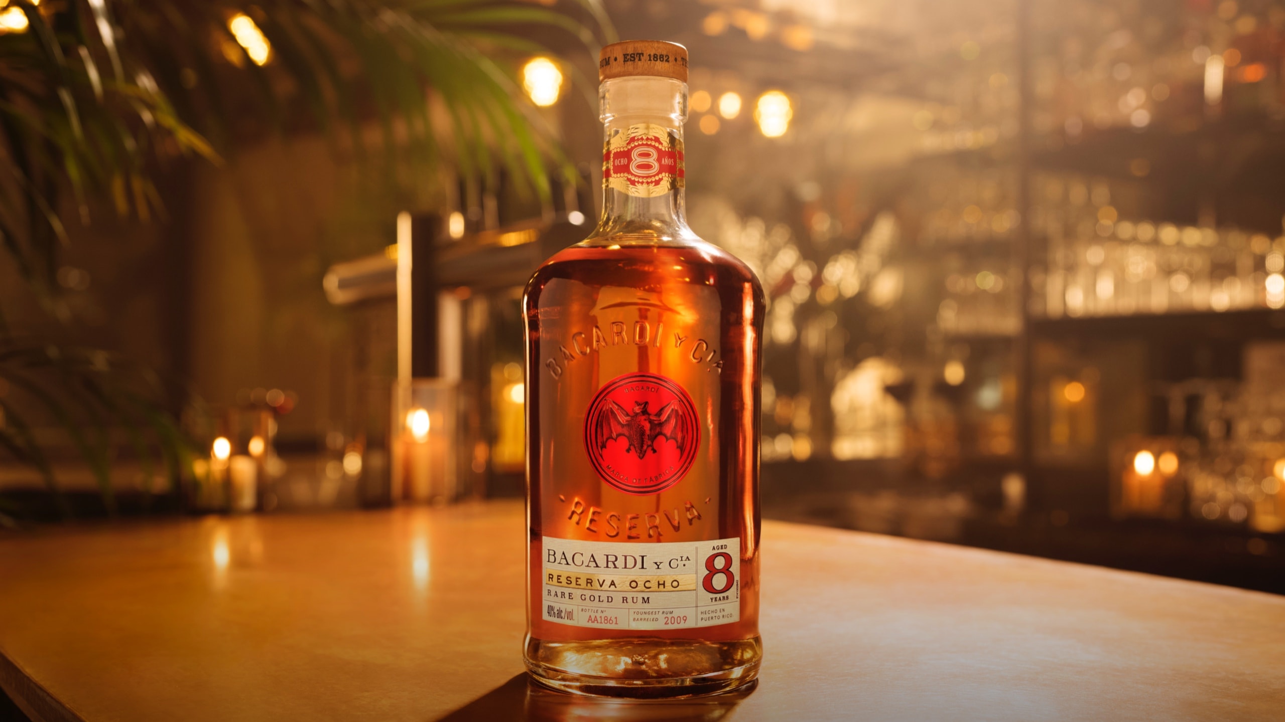 BACARDÍ Reserva Ocho rum bottle standing prominently with soft, warm illumination.