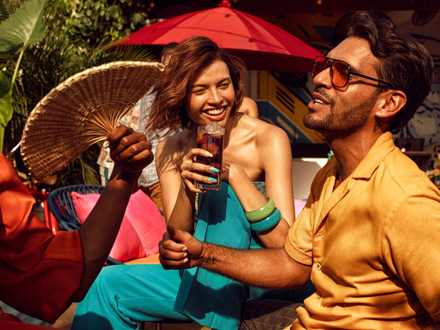 People gathered outdoors, sharing drinks and enjoying a social moment.