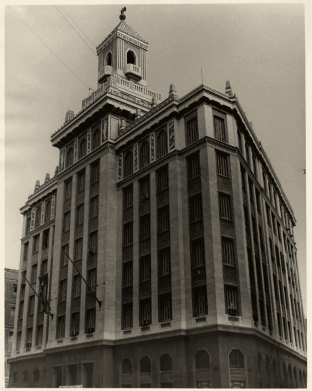 Sepia-toned photograph of grand Art Deco BACARDÍ skyscraper with distinctive tiered tower and bat sculpture.