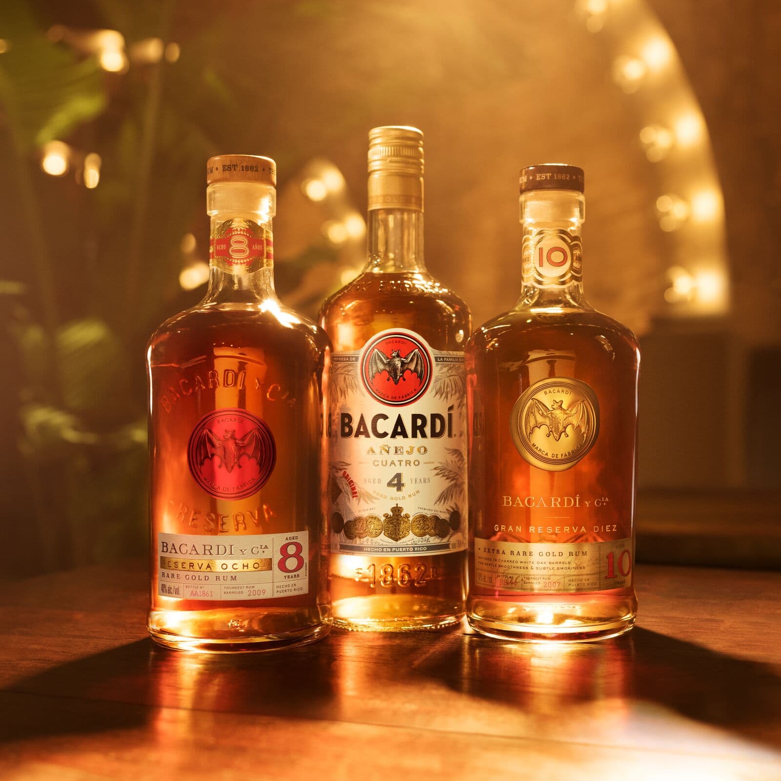 Three BACARDÍ rum bottles: Reserva Ocho, Añejo Cuatro, Gran Reserva Diez.