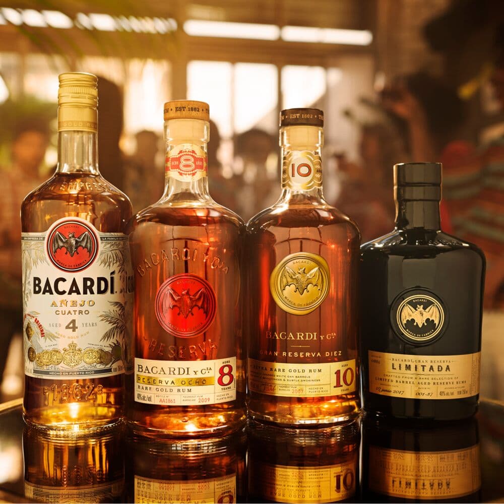 Four BACARDÍ rum bottles arranged in a row, showcasing different aged varieties.