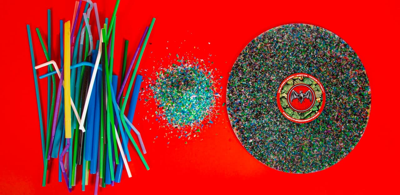 Overhead view of recycling process transforming plastic straws into a BACARDÍ-branded vinyl record.