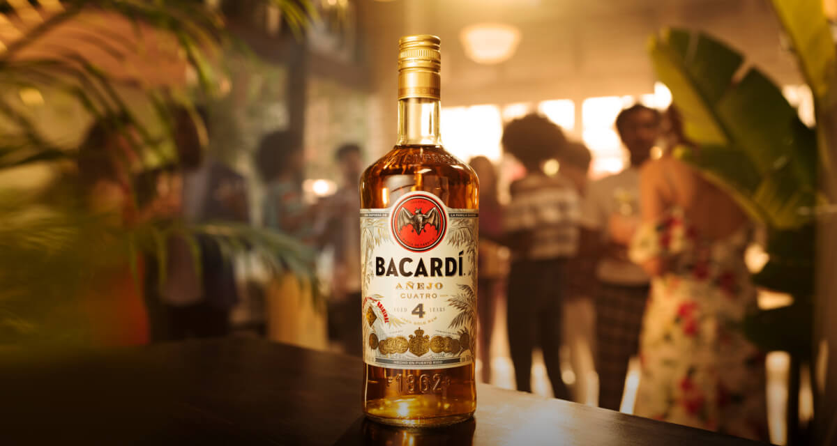 BACARDÍ Añejo Cuatro rum bottle standing prominently with clear label and distinctive design.