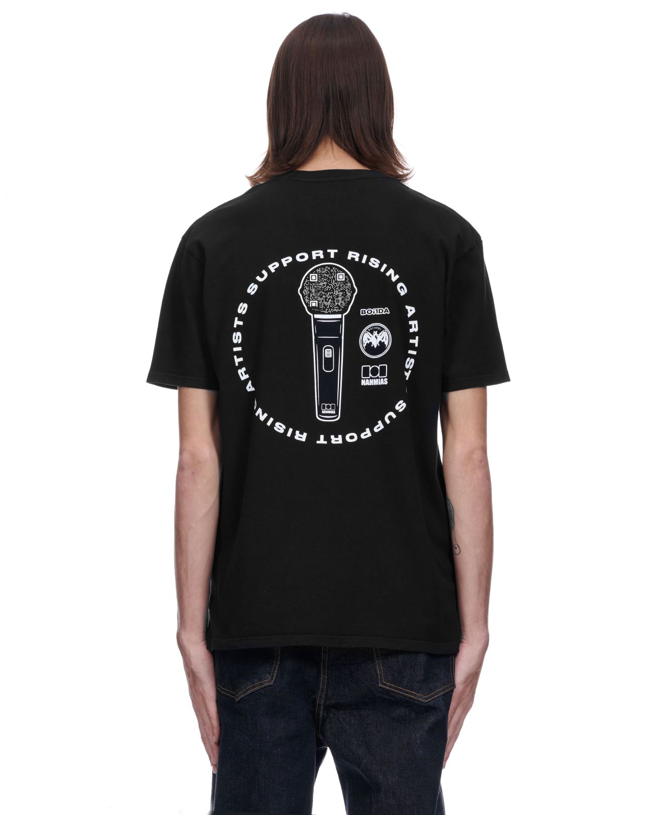 Person wearing a black t-shirt with a white graphic design featuring a microphone and QR code.