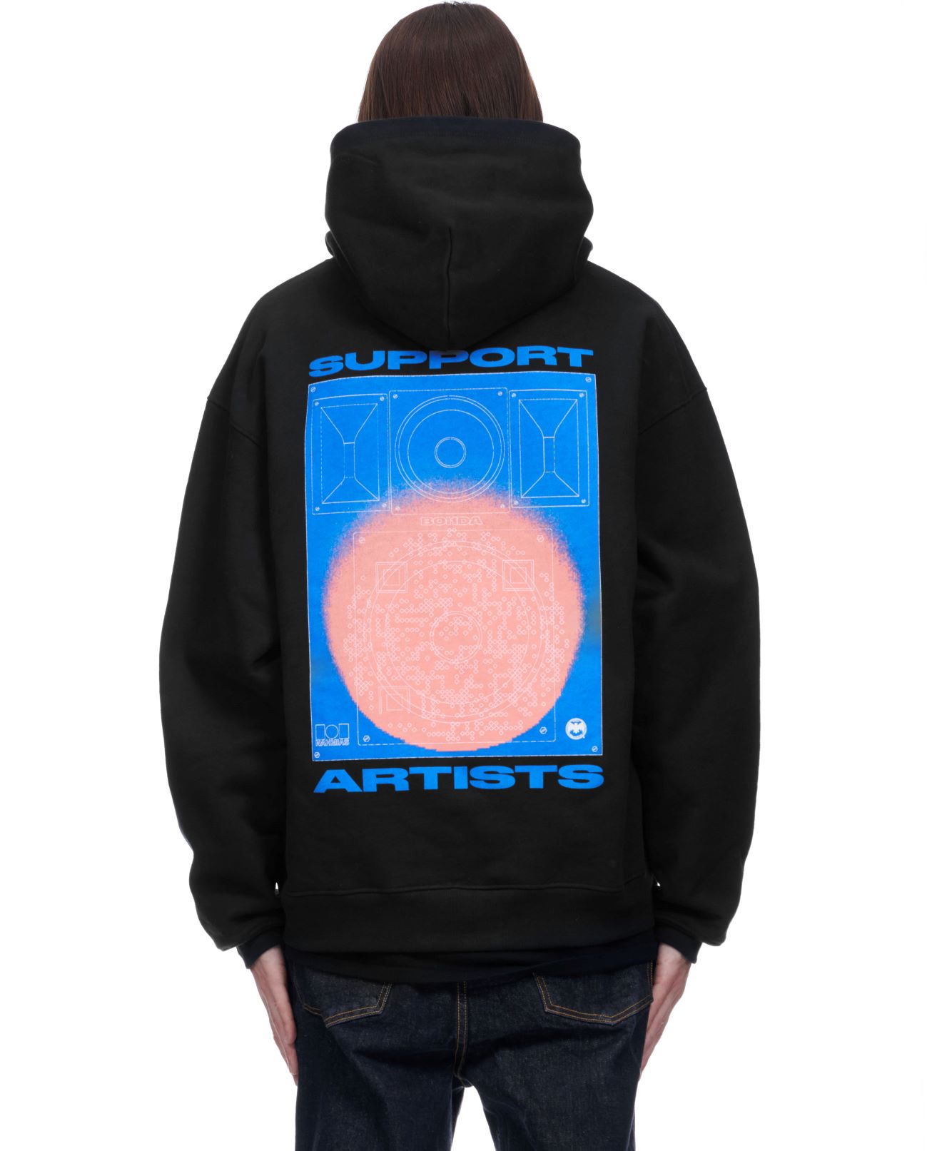 Person wearing a black hoodie with a graphic design of a blue speaker outline and orange circular pattern.