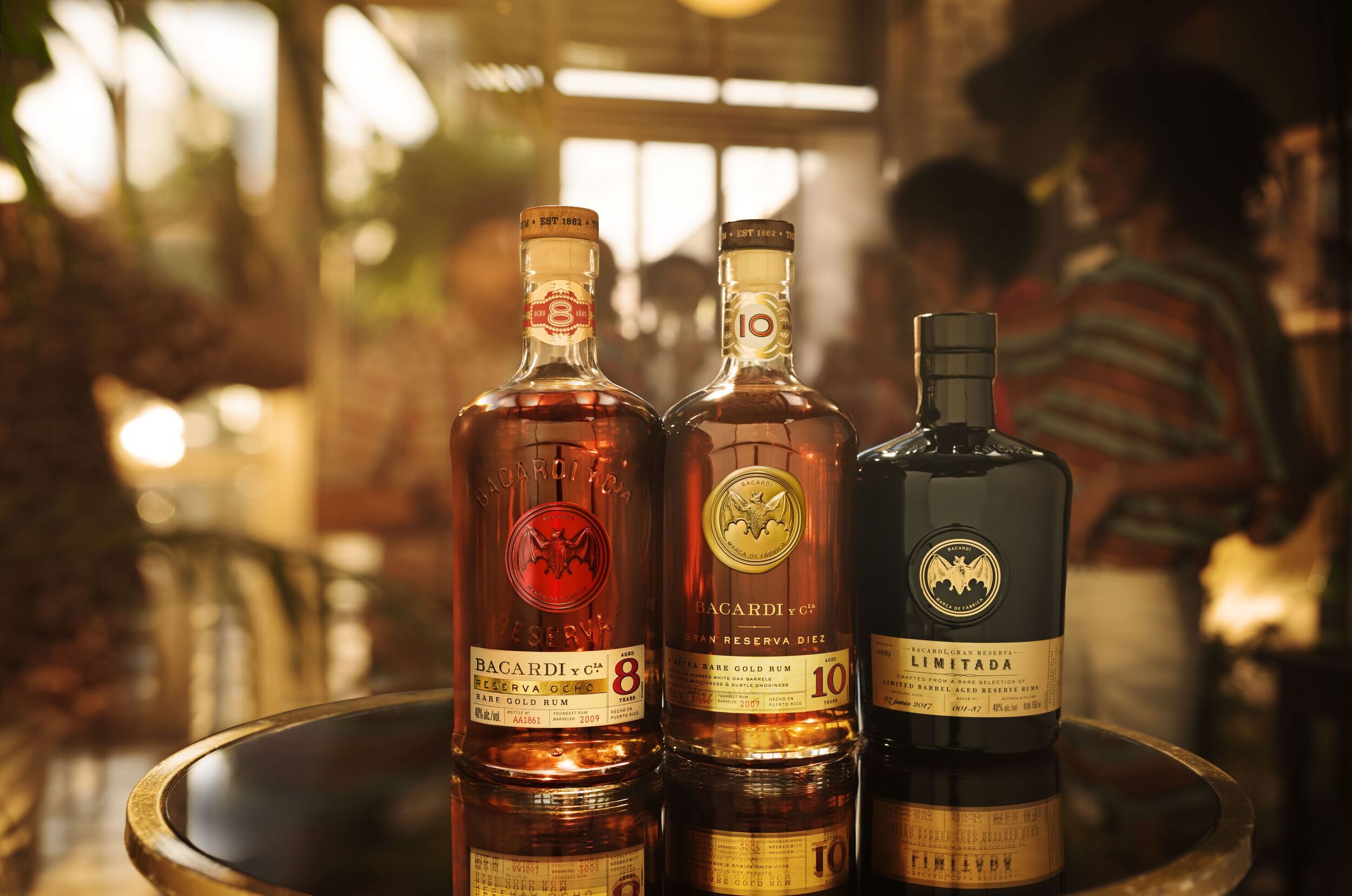 Three BACARDÍ Reserva rum bottles arranged in a row, showcasing Ocho, Diez, and Limitada variants.